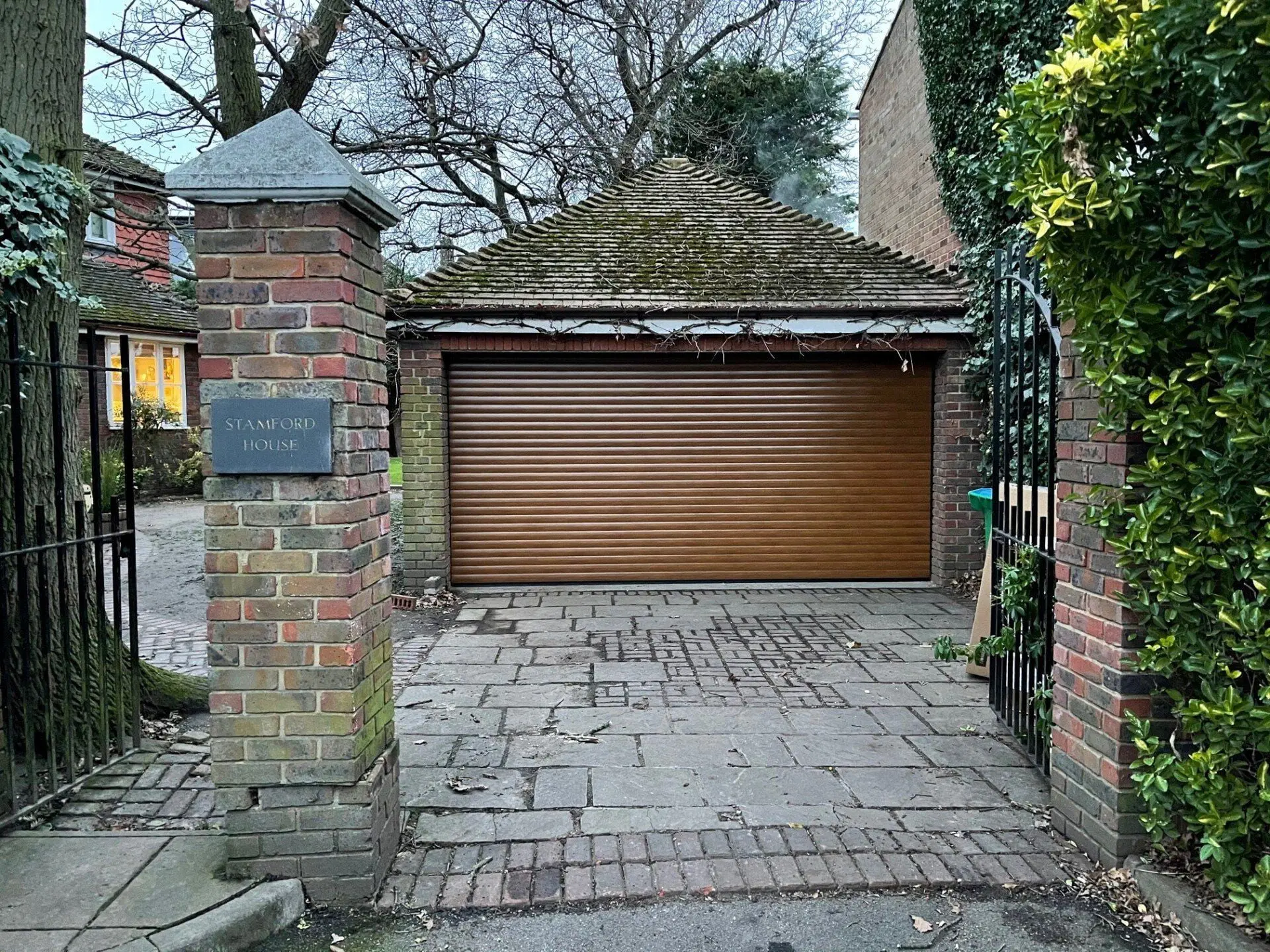 Oak effect roller garage door fitted to a period property by Doors 4 Garages Ltd